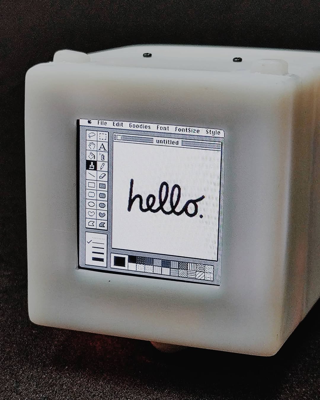 Micro Macintosh showing MacPaint hello screen
